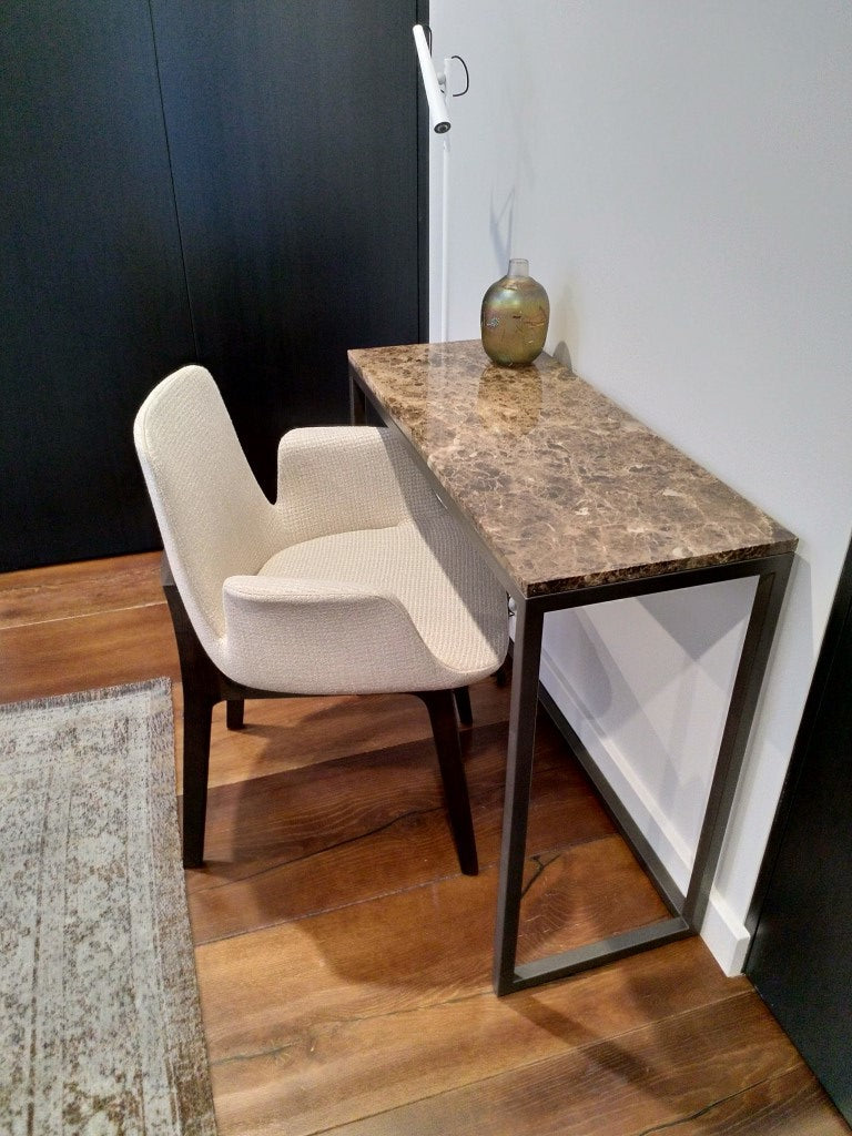 Small table with a mirror and chair on a wooden floor