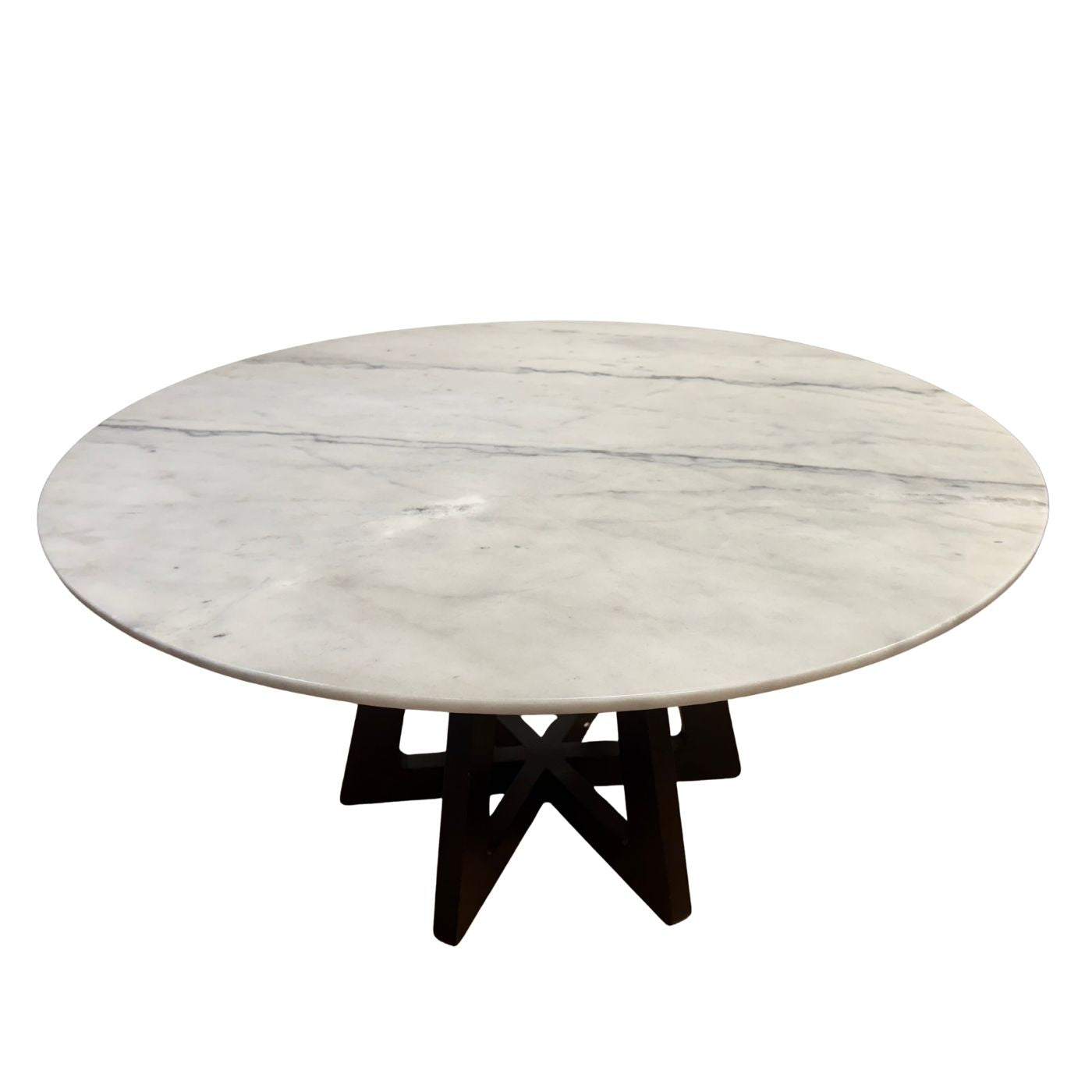 Round marble table with a black metal base on a white background