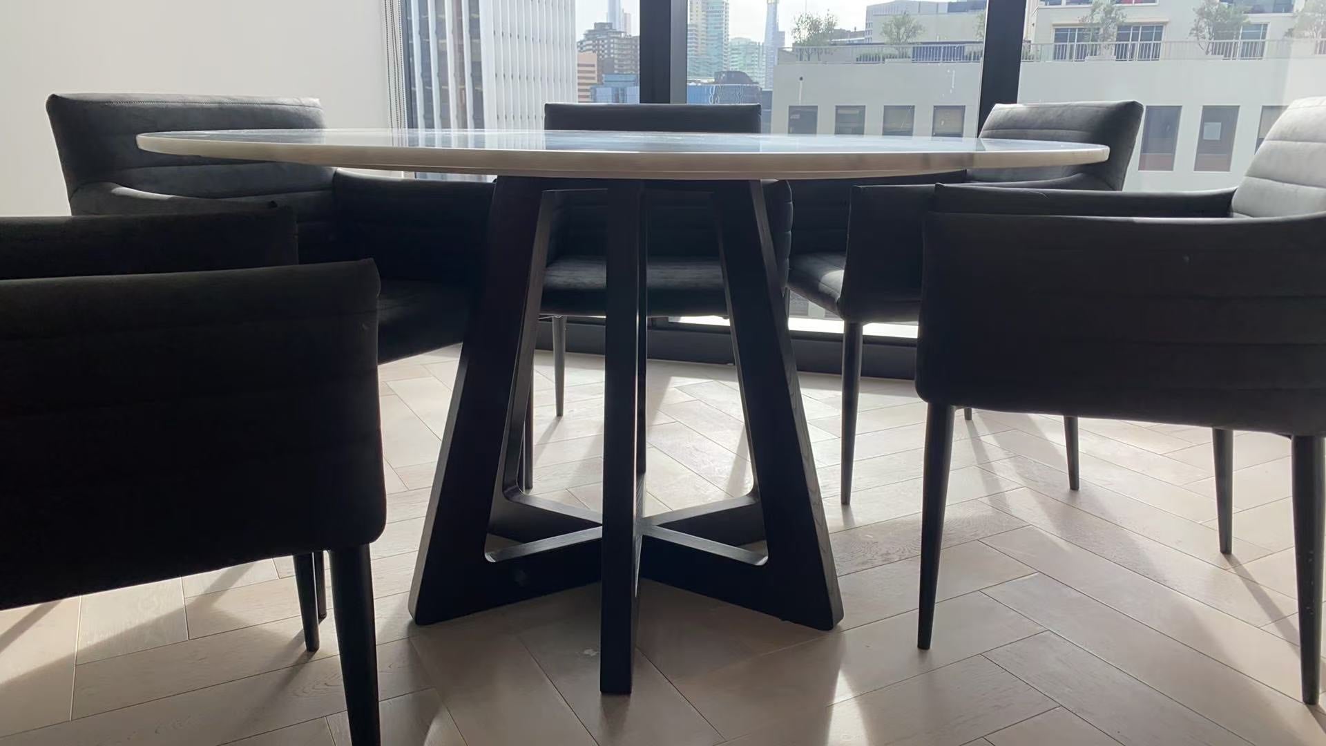 Round dining table with chairs in a modern interior setting