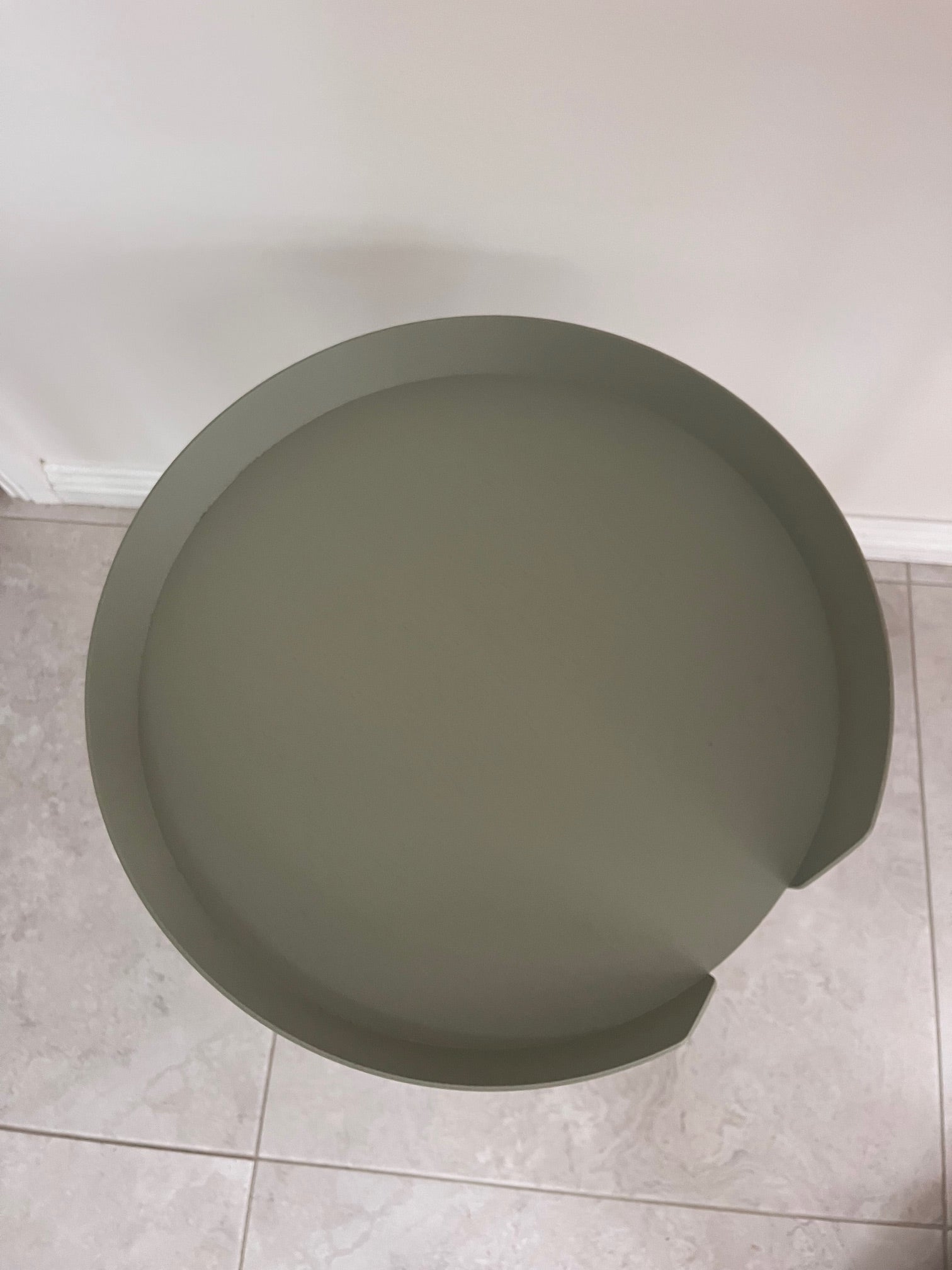 Green tray on a tiled floor
