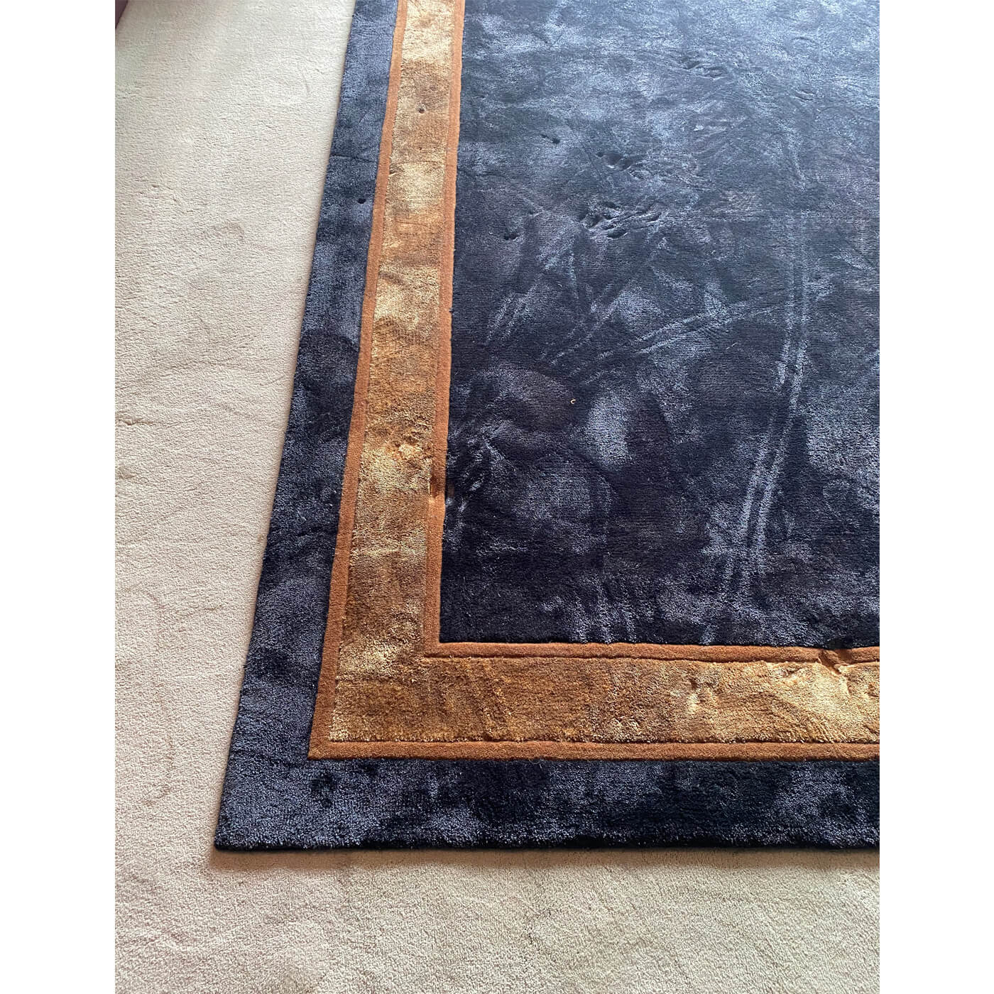 Black rug with caramel border