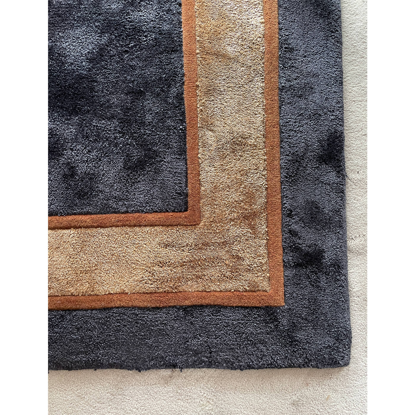 Black rug with caramel border