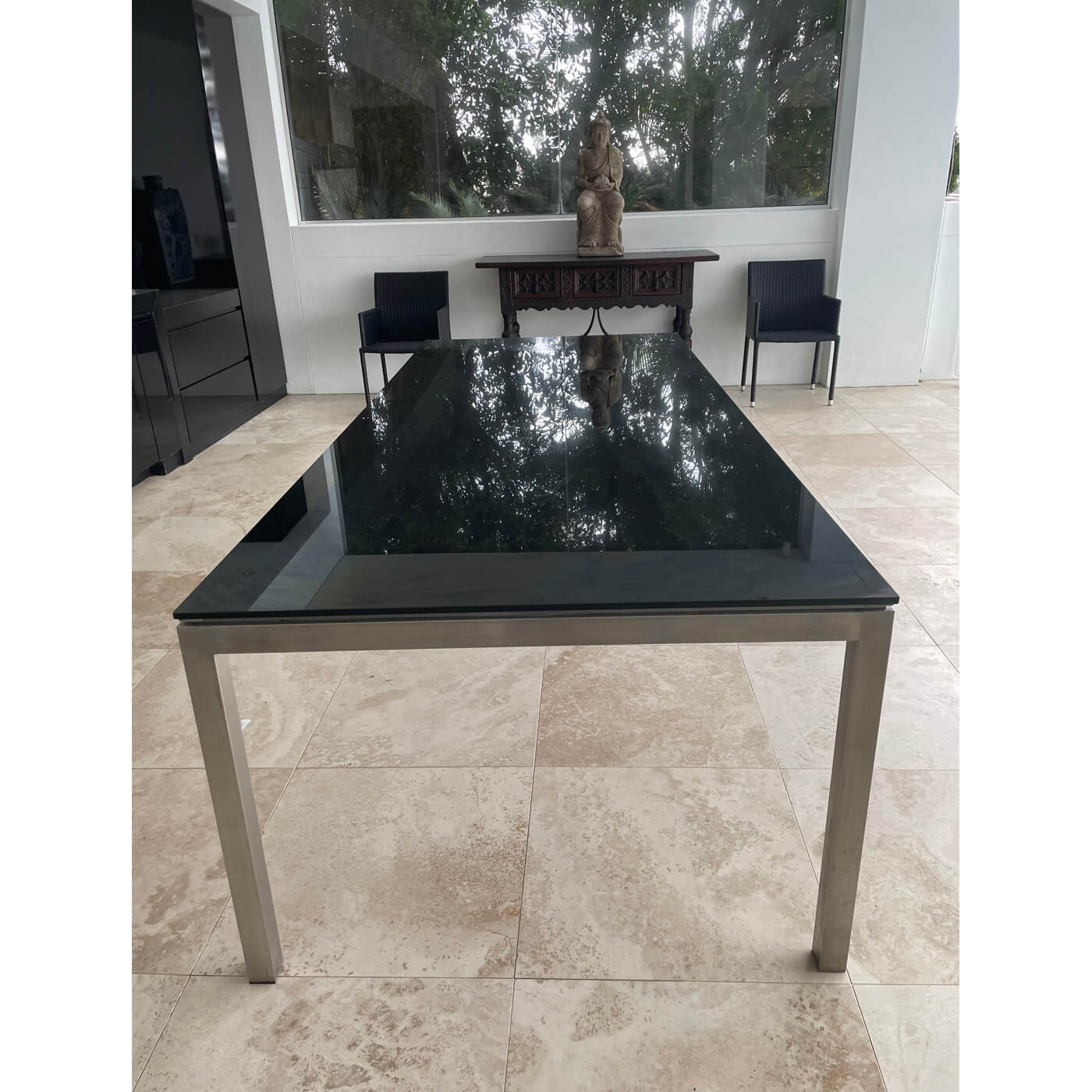 Outdoor dining table with black glass top