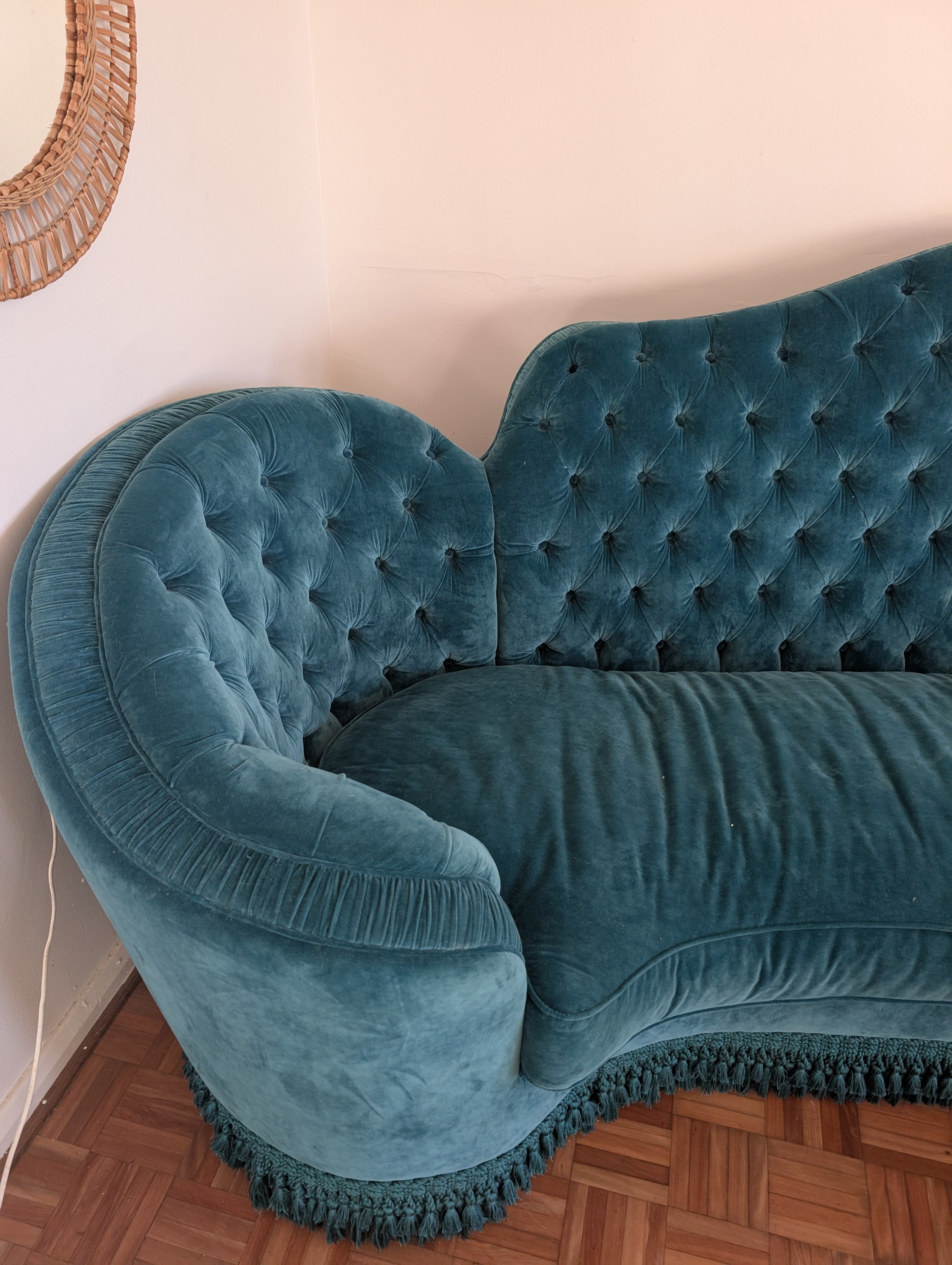 Blue velvet sofa against a white wall