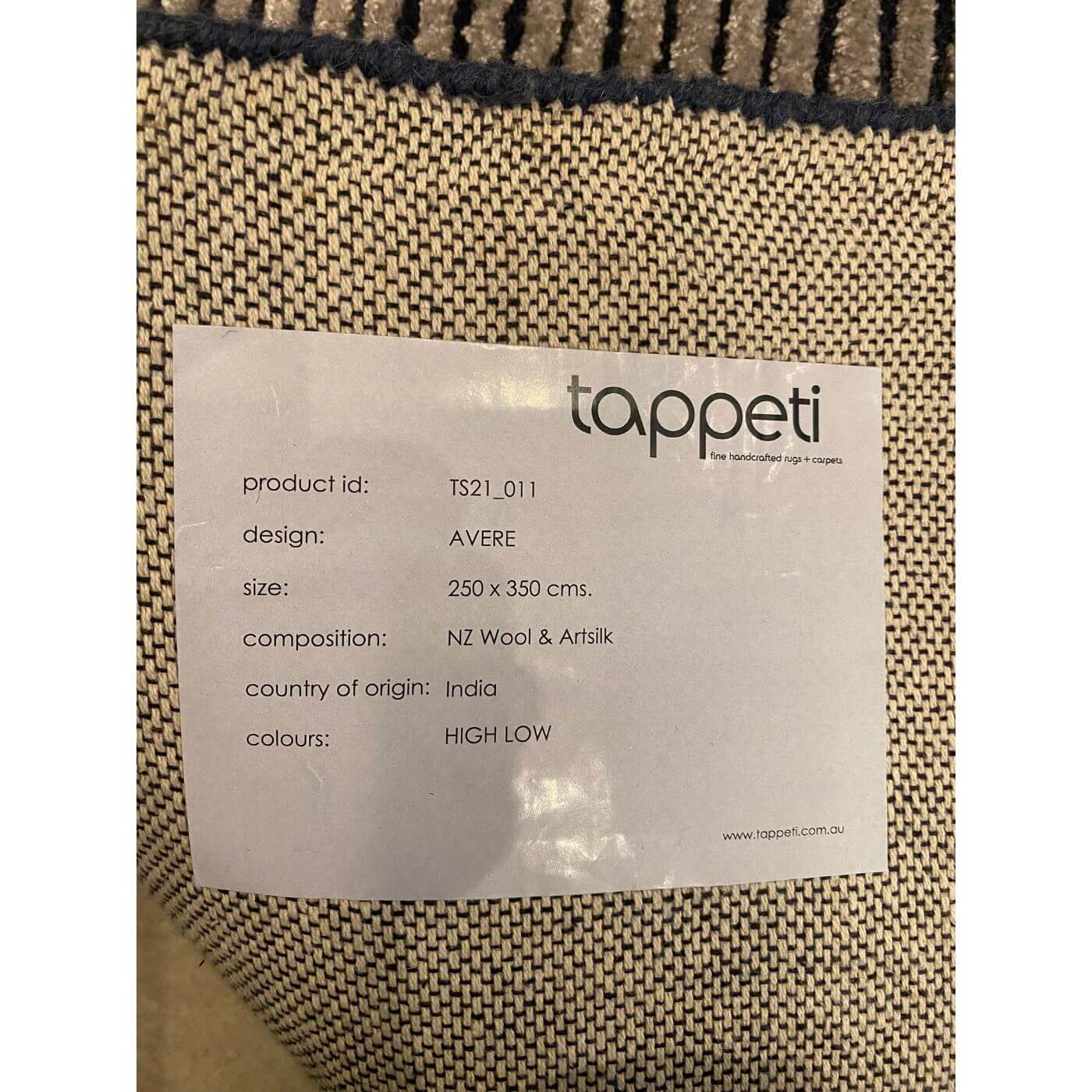 Label on a woven fabric product with 'tappeti' branding and product details.
